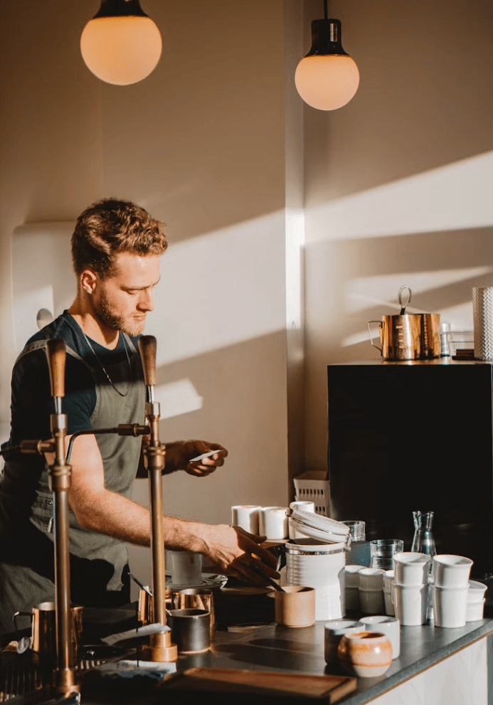 Barista checking a staff roster on a phone