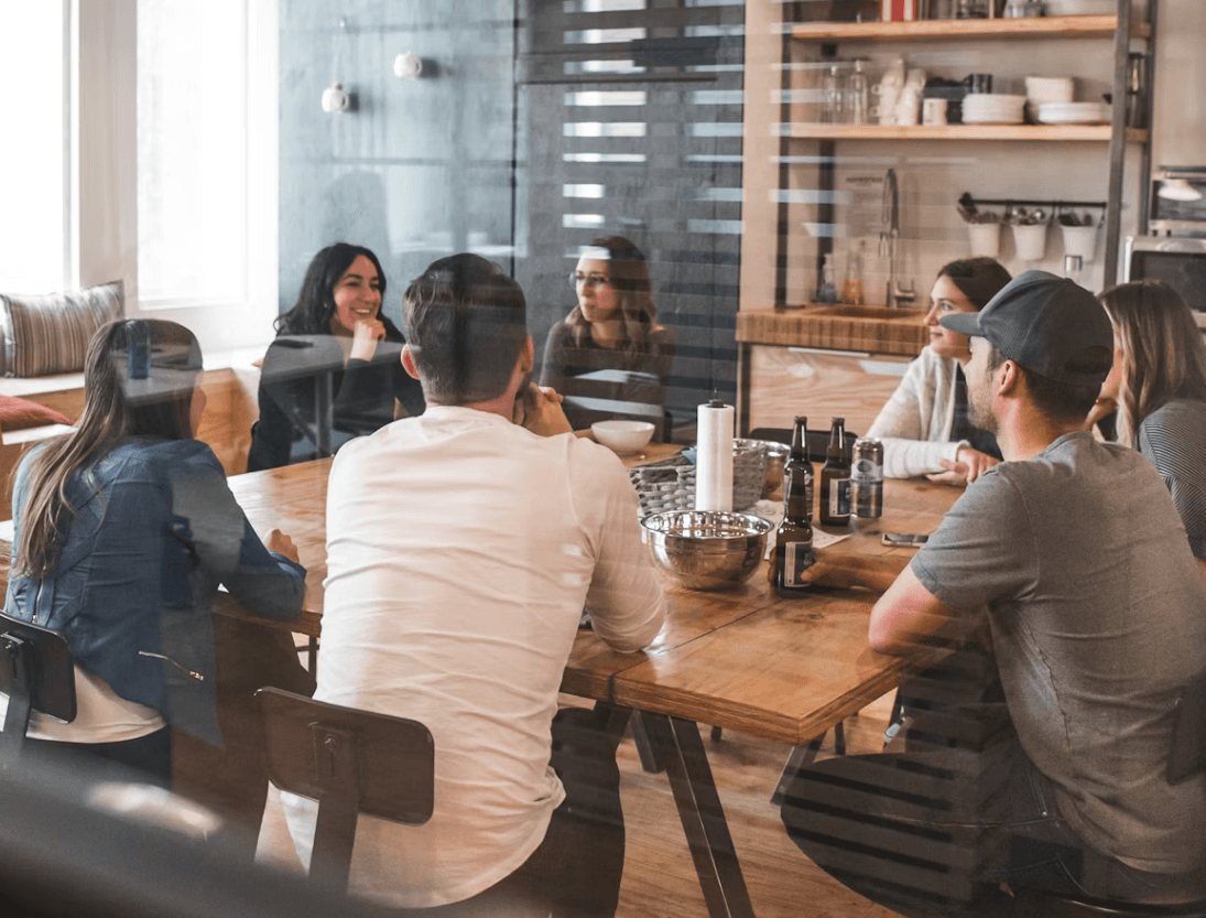 A hospitality team catching up around a table